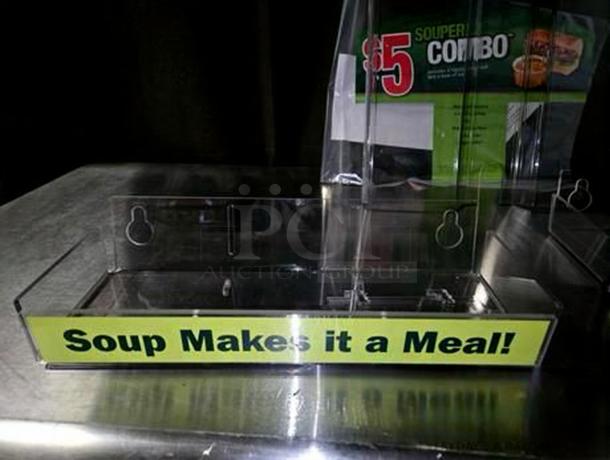 Clear acrylic countertop display rack in like-new condition, dual-slot design for soup and sandwich promos, labeled "Soup Makes it a Meal!"