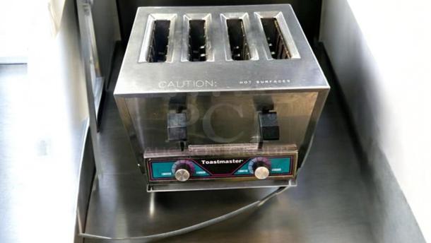 Toastmaster TP409 commercial 4-slot toaster in outstanding condition, 120V, fully tested and working, with visible caution label.