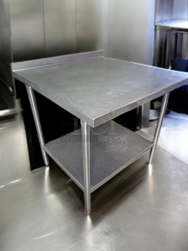 Stainless steel prep table with backsplash, 36"x36"x36". Commercial grade, heavy-duty, fully cleaned, unbranded.