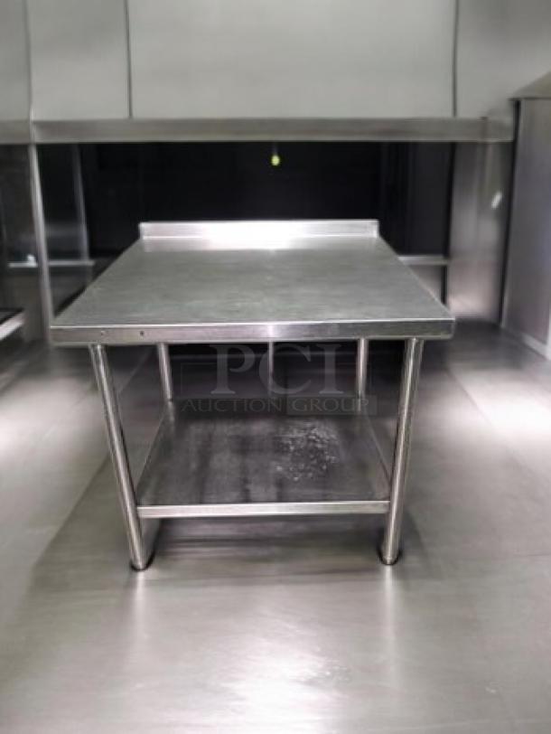 Stainless steel prep table with backsplash, 36"x36"x36". Remarkable condition, commercial grade, heavy-duty, fully cleaned.