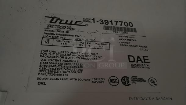 Label on True GDM-45-HC-LD refrigerator. Shows model, voltage (115V), and energy-saving certifications. Made by True Manufacturing Co., Inc.