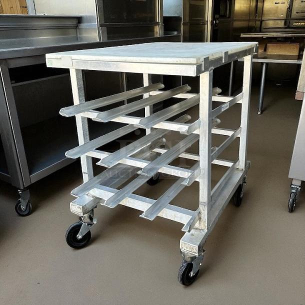 New Age half-size mobile aluminum can rack for #10 & #5 cans. Excellent condition, without cutting board, on wheels.