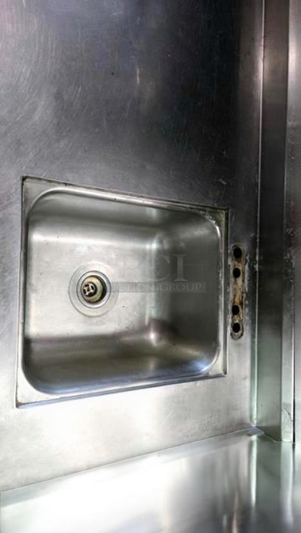 Stainless steel work table with integrated sink by Custom Commercial Fabrication. Features can opener mount. Top-tier condition.