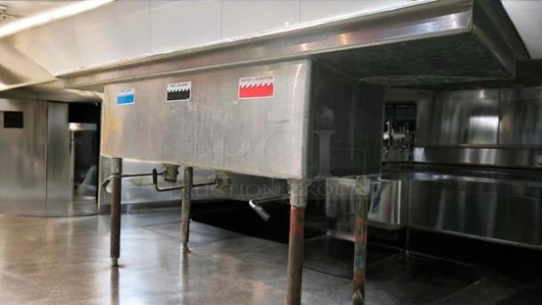 Stainless steel 3-compartment sink, 84"W x 27"D x 44"H, with faucet cutout and electrical access, excellent condition.