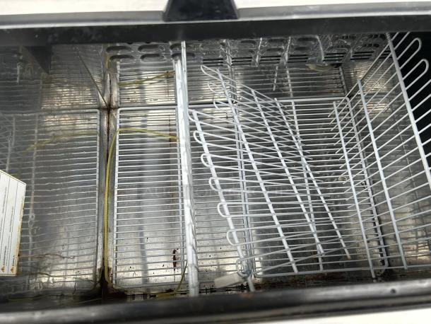 Turbo Air TBC-50SB-N6 bottle cooler interior with wire racks, showing clean and spacious cooling area, tested and working.