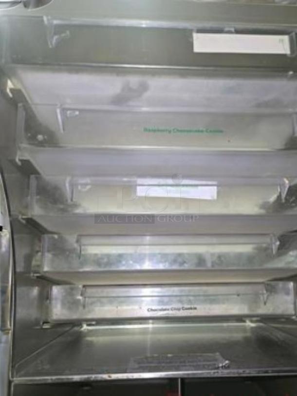 Subway 4-tier cookie display case in superb condition, fully tested. Features include clear shelving and labeled sections for bakery items.