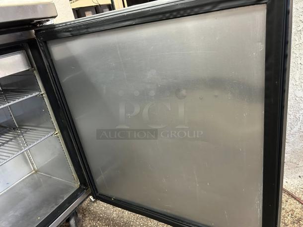 True TSSU-27-08 refrigerated prep table, solid 1 door, tested, stainless steel, shelves visible, great condition.