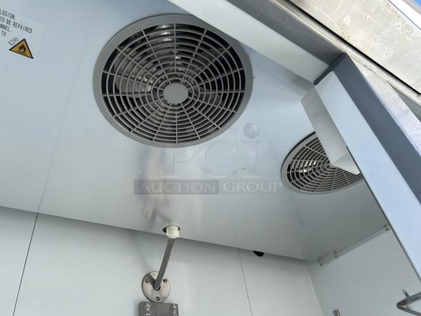 Cooler Depot XB54F-HC commercial refrigerator interior showing dual ventilation fans, stainless steel finish, in excellent condition.