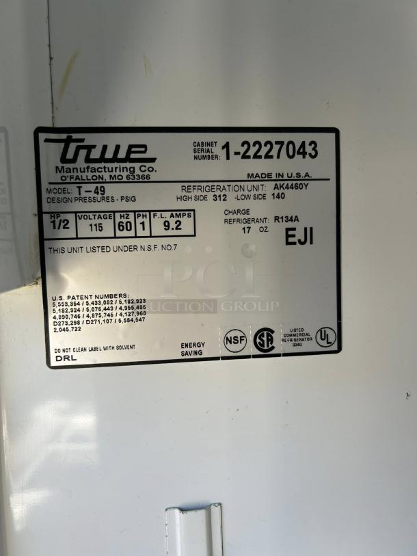 Label on a True T-49-HC refrigerator, showing model info, serial number 1-2227043, NSF and UL certifications, and R134A refrigerant.