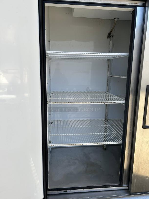 True T-49-HC reach-in refrigerator with solid doors, 54 1/8" width, tested and working, features spacious interior shelves.