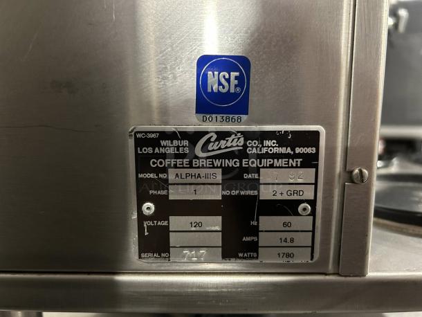 Curtis Alpha-III-S coffee brewer label; model details and specifications visible, including voltage, phase, and serial number.