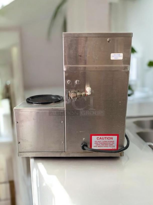 Curtis Alpha Automatic Coffee Brewer with dual warmer, stainless steel, excellent condition, tested and working, visible caution label.
