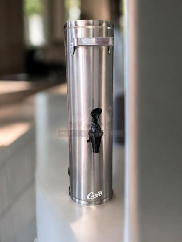 Curtis TLXA2201G iced tea dispenser in stainless steel, round design, excellent condition, tested and working, with Curtis logo.