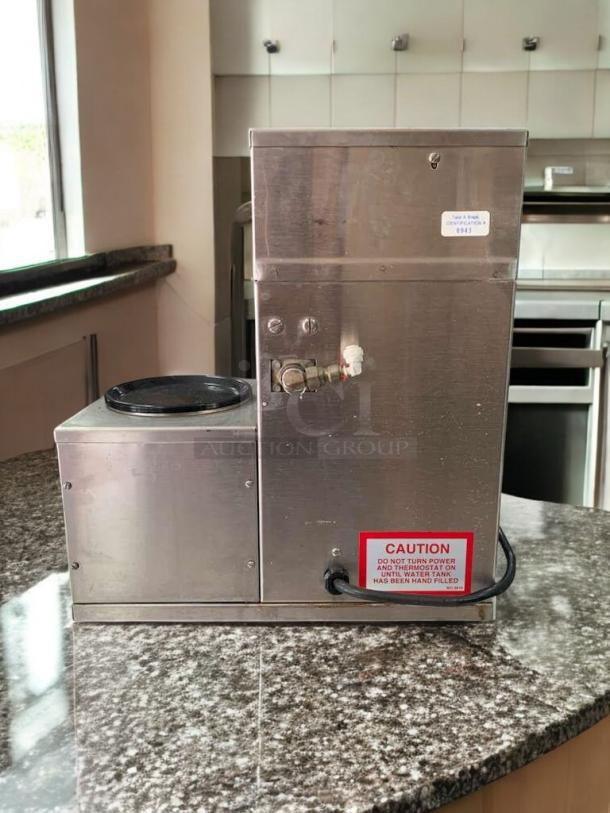 Curtis Alpha G3 Coffee Brewer, excellent condition, 3 warmers, stainless steel, tested and working, caution label visible.