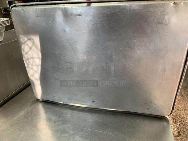 Universal Commercial Grade full-size stainless steel sheet pan, used condition, minor surface scratches, durable bake tray.