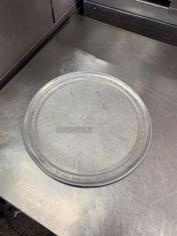 Universal Commercial Bakeware 16" round aluminum pizza pan, commercial grade, slightly used, visible surface marks.