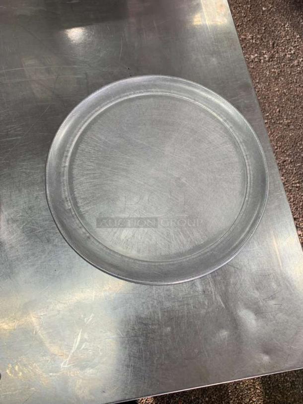Universal Commercial Bakeware 16-Inch Round Aluminum Pizza Pan, commercial grade, lightly used, visible surface scratches.