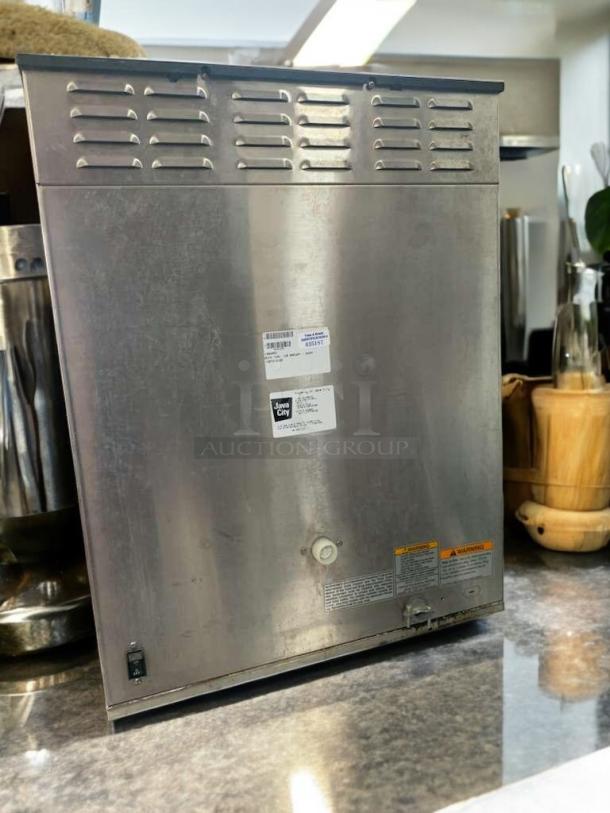 BUNN Dual Brew Coffee Maker, stainless steel, digital controls. Excellent condition, tested and working. Tags show model and warnings.