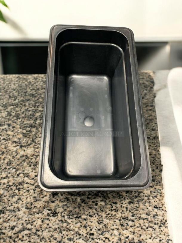 Black 1/9 size food storage container, 4" deep, made of polycarbonate. Excellent condition, NSF certified, cleaned and tested.