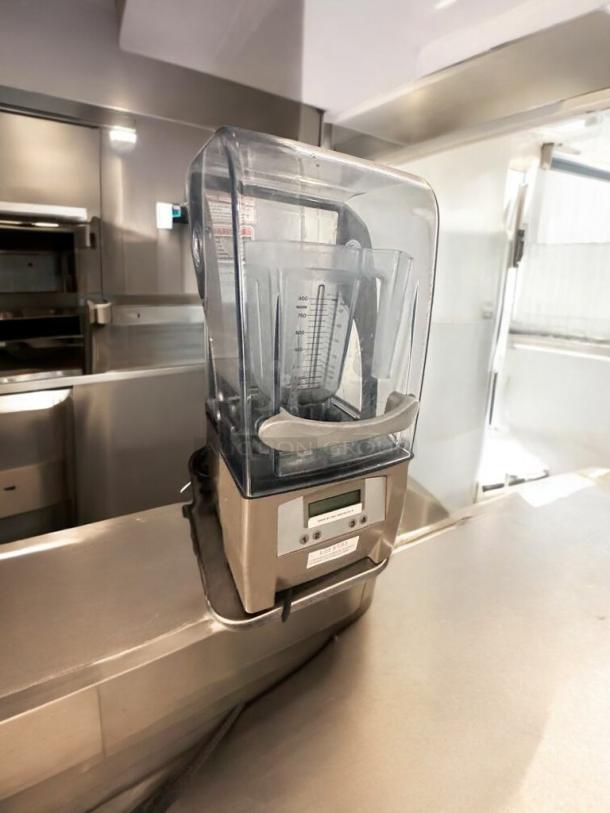 Blendtec Stealth 885 commercial blender with sound enclosure, pristine condition. Features digital display, model label visible.
