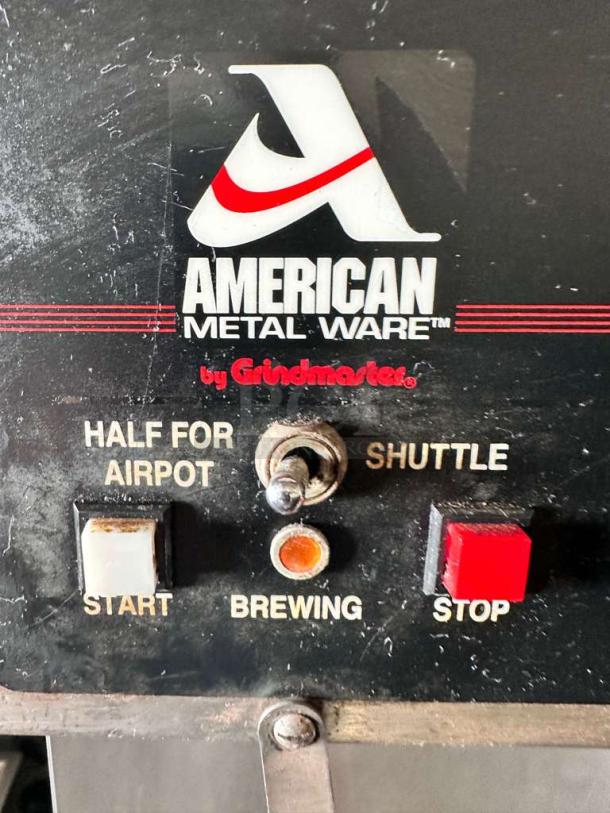 American Metal Ware by Grindmaster control panel with start, stop, and brewing switches. Labels for airpot and shuttle functions visible.