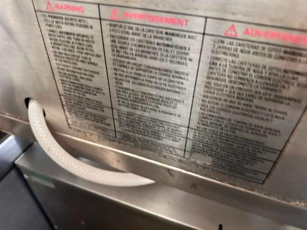 Mazzer Robur Electronic Grinder label, listing warnings in multiple languages; indication of 110V usage, made in Italy.