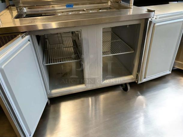 Delfield 4448NP refrigerated sandwich prep table in outstanding condition, open doors, shelves visible, 115V, fully tested.