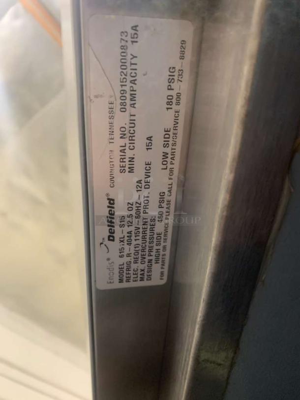 Label on Delfield 6151XL-S refrigerator, showing model, serial number, voltage requirements, and pressure specifications.