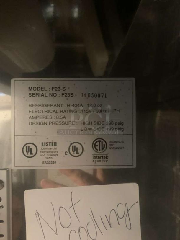 Norlake AdvantEDGE F23-S refrigerator label indicating 115V, R-404A refrigerant, 8.5A. Needs cooling repair. Model F23-S.