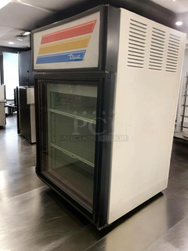 True GDM-05-LD glass door merchandiser, pristine condition, 115V, fully tested, shelving inside, True logo on top.