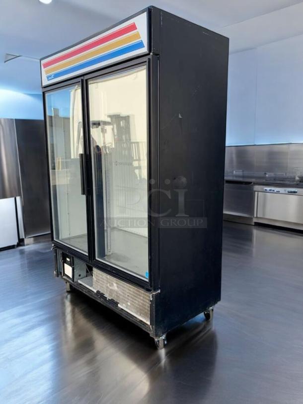 Pristine True GDM-49F-LD two-door freezer merchandiser in black, tested and working, with vibrant stripe detail on top panel.