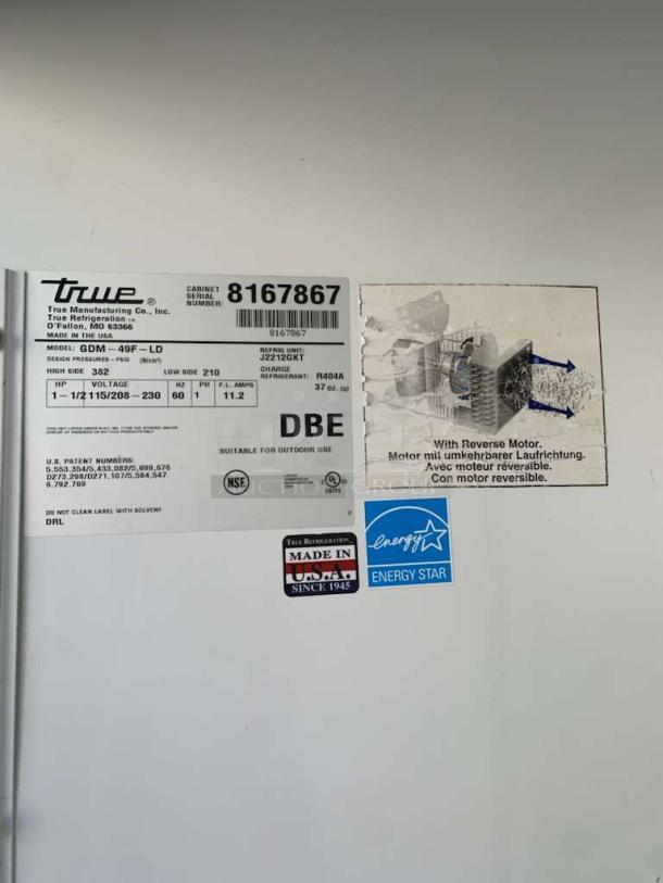 Label of True GDM-49F-LD freezer merchandiser showing model, voltage, certification markings, and "Made in USA" badge.