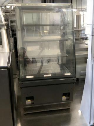 Pristine heated display case, full-view glass merchandiser. Tested, working, with shelves and visible control panel.