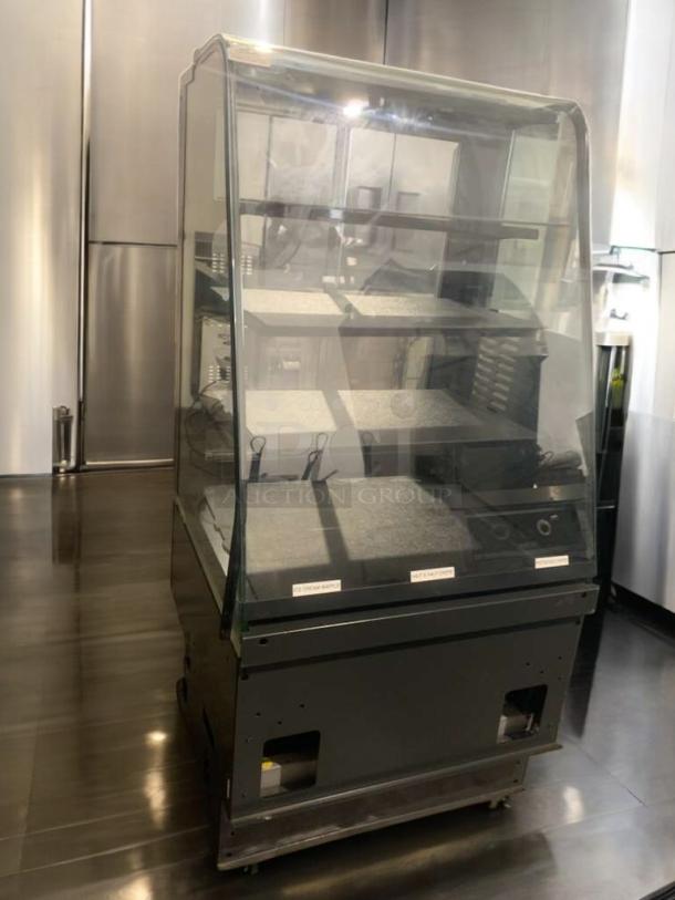 Pristine heated display case with full-view glass. Features multiple shelves, clean condition, and tested functionality.