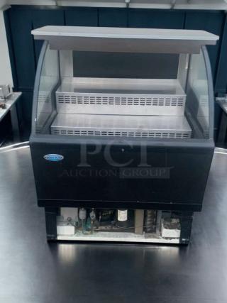 Federal Industries refrigerated curved-glass display case in immaculate condition, fully tested and working, ideal for bakery/deli.