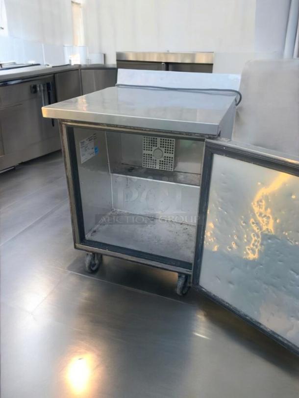 Pristine True TWT-27F under-counter freezer, 27", 115V, fully tested. Features stainless steel build, caster wheels, open door.