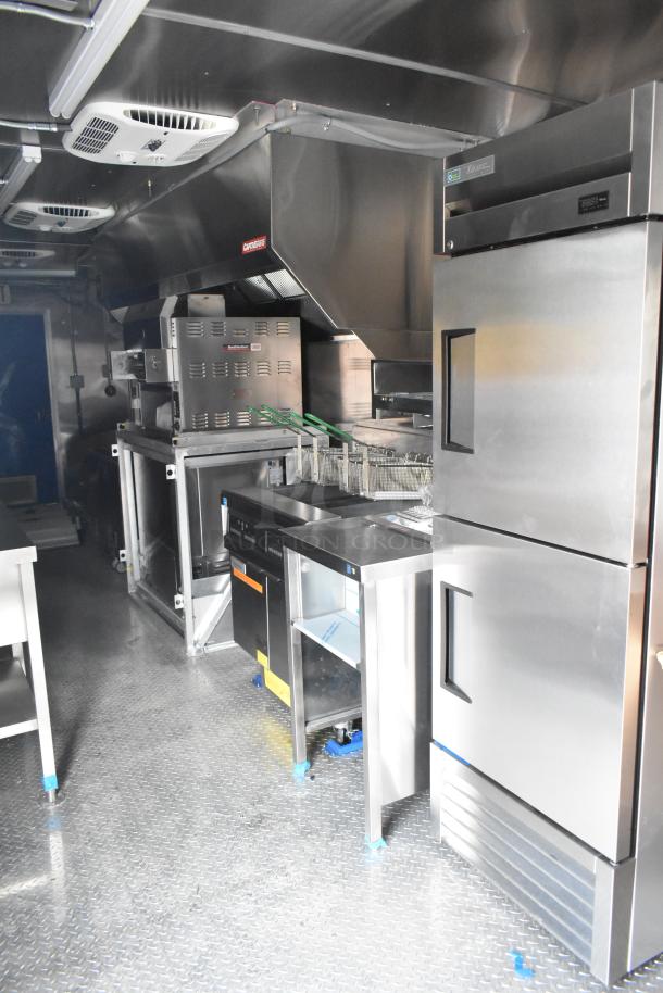 Brand new, fully outfitted 2021 food trailer with CaptiveAire grease hood, 3 True freezers, cooler, fryers, sinks.