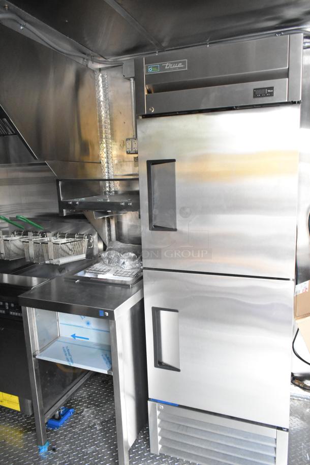 Brand new 2021 food trailer with stainless interior, CaptiveAire grease hood, True freezers, cooler, and fryers.