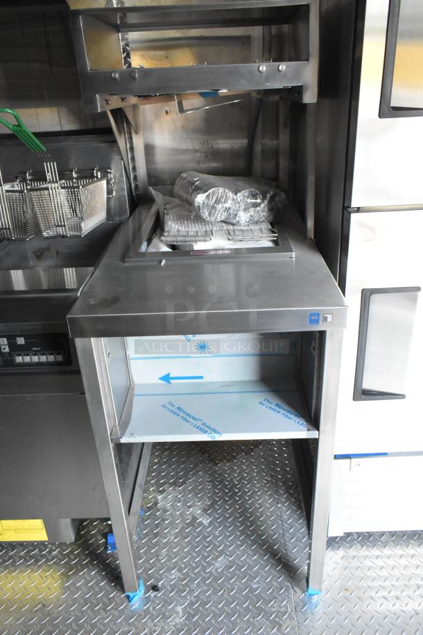Brand new food trailer interior with True freezers, fryer, and stainless steel setup. Includes CaptiveAire grease hood.