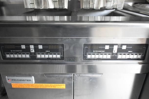 Frymaster CM3.5 control panel in a new 2021 food trailer, featuring digital displays and fryer baskets above.