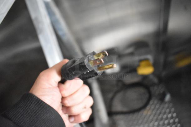 Close-up view of a power connector in a brand new 2021 food trailer. Note the sturdy grip and standard prongs.