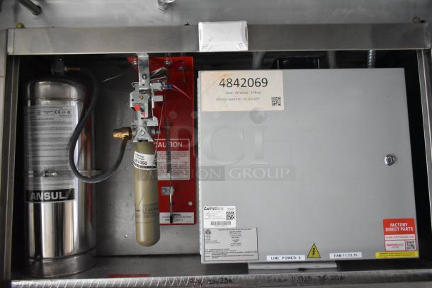 Ansul fire suppression system and CaptiveAire grease hood control panel inside a mobile food trailer, labeled for electrical safety.