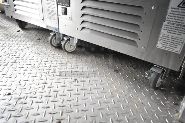 Alt text: Mobile kitchen trailer with CaptiveAire grease hood, freezers on diamond plate flooring. Ideal for ghost kitchens.