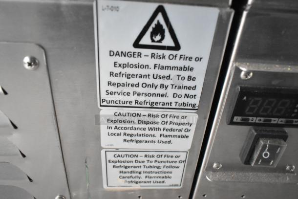 Warning labels on a 2021 food trailer indicating fire and explosion risks due to flammable refrigerants.