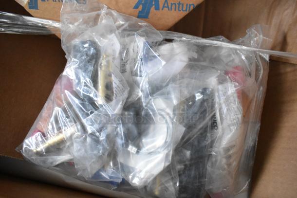 Plastic bags filled with assorted parts and components for a food trailer; box labeled "Antunes" suggests manufacturing or supply brand.
