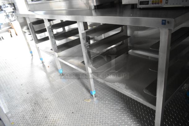 Stainless steel interior of a new 2021 food trailer featuring shelving and countertops, perfect for diverse kitchen setups.