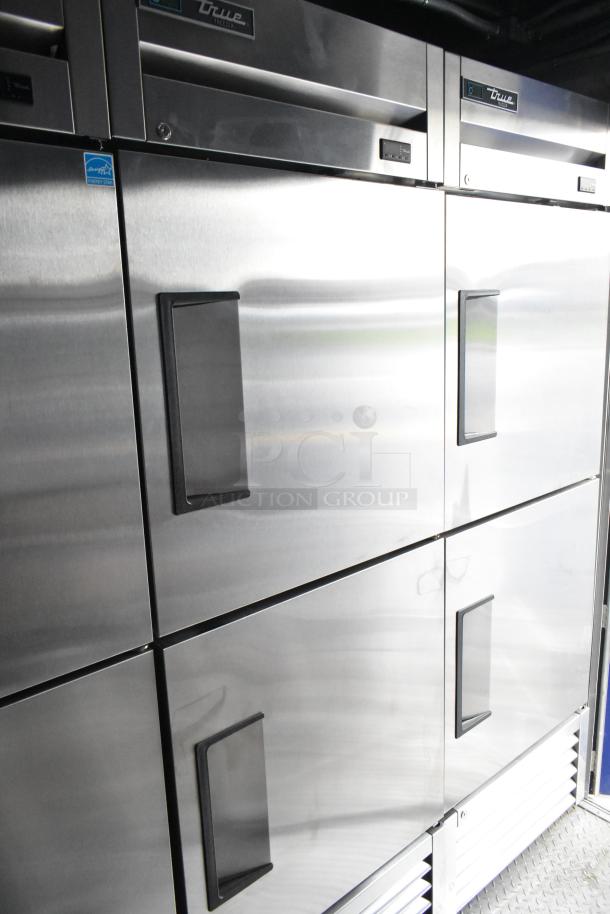 Stainless steel True Freezers and Cooler in a food trailer, featuring ENERGY STAR labels, ideal for a mobile kitchen.