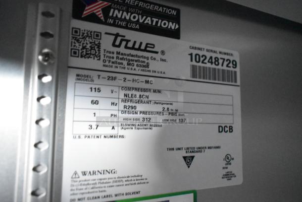 Label on a True freezer, model T-23F-2-HC-MC, showing specs: 115V, refrigerant R290, serial number 10248729. Made in USA.
