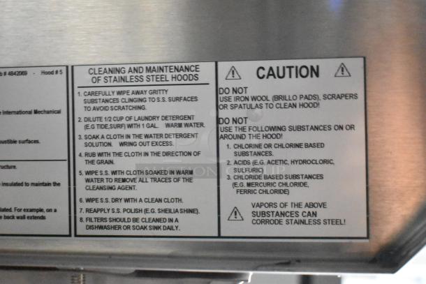 Label showing cleaning and maintenance instructions for stainless steel hoods. Includes warnings against corrosive substances.