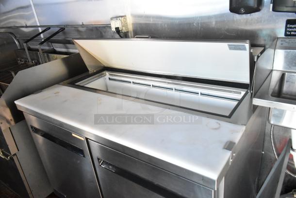 Brand new 2021 food trailer with open stainless steel prep area, fryers, and commercial sinks; ideal for versatile cooking setups.